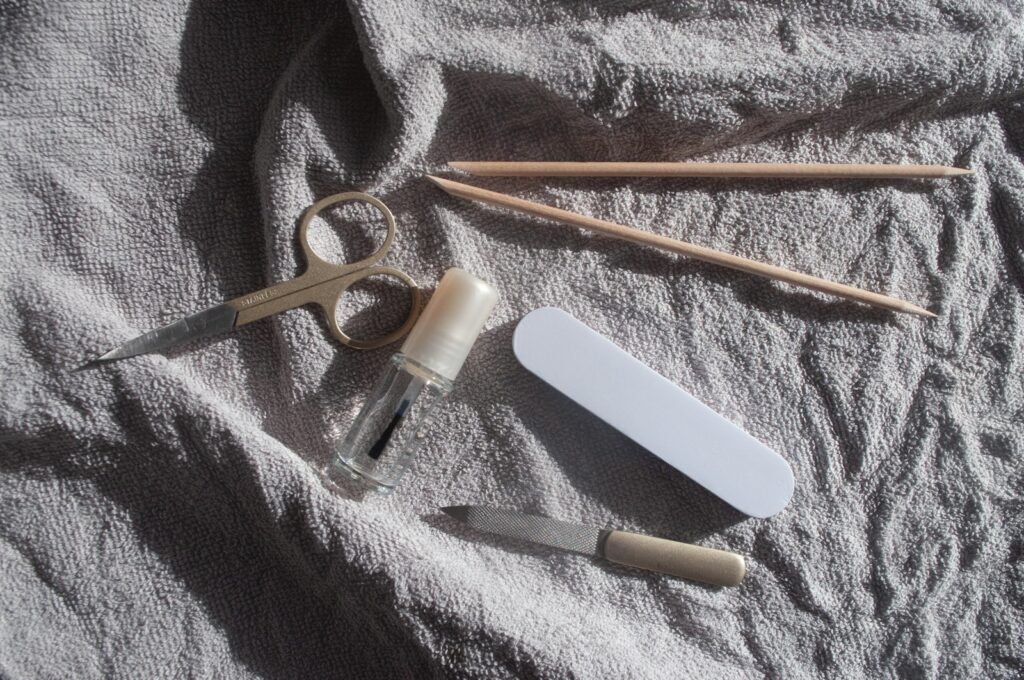 Beginner nail care kit with manicure tools laid out on a white towel