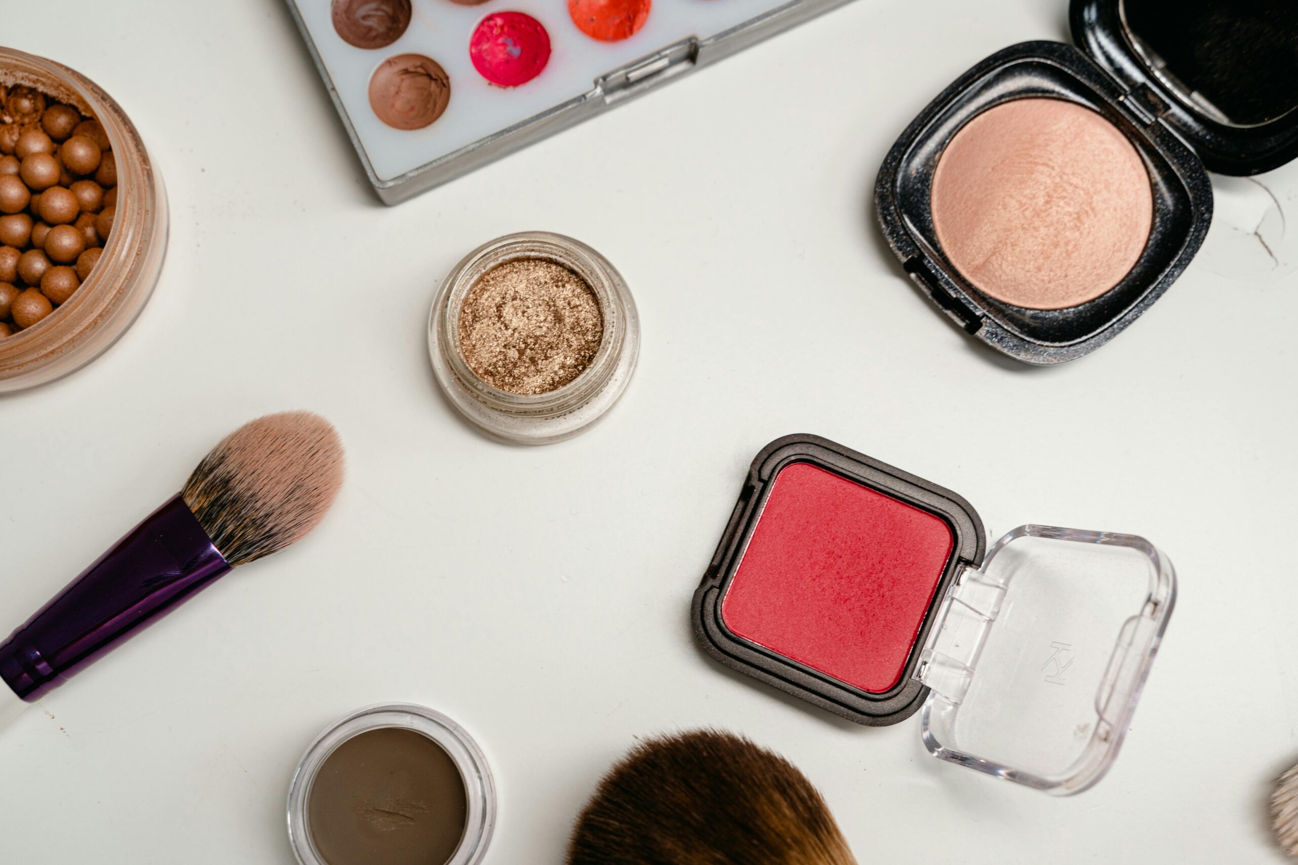 Makeup products for mature skin over 40 including foundations, blush, and beauty brushes
